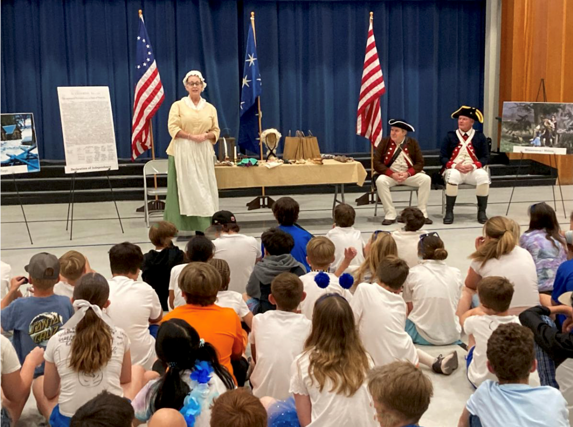 Volunteers of the Sacramento Chapter School Guard standing in authentic Revolutionary War uniforms and period outfits