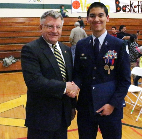 SAR Officer presenting the official JROTC leadership decoration award medal to Cadet Cameron Castillo